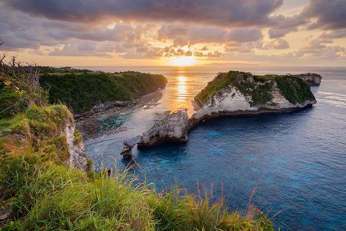 Island in Atuh Beach, Nusa Penida, Indonesia, viewed from the clifftop at sunrise.