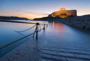 Fort Grey slipway illuminated at dusk.