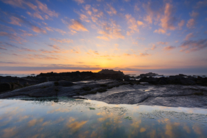 Clouds at sunset, reflected in a rockpool at Grandes Rocques.