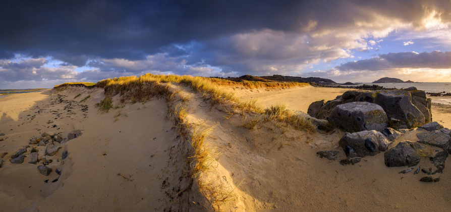 Panoramic photo of Oyster Point, Herm at sunset in winter.