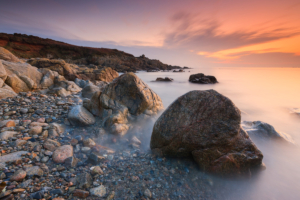 Long exposure of the shoreline at L'eree headland at sunset.