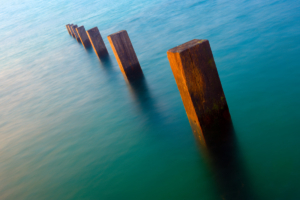 Timber groynes on Vazon Bay at high tide.