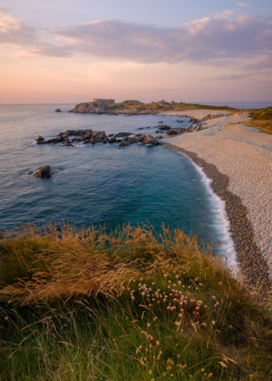 Fort Le Marchant headland bathed in warm light.