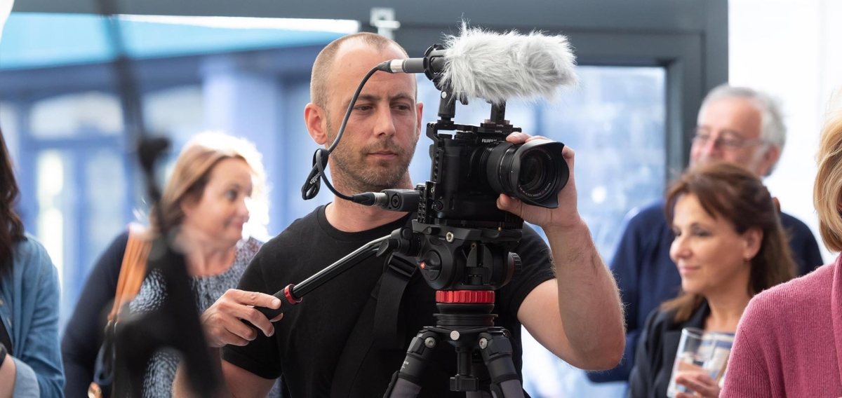 Dan Guerin operating video camera at an event