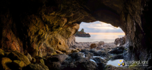 View out of a cave at Petit Port, Guernsey, overlooking the pristine sand at low tide.