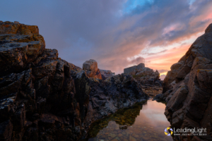 Fort Pembroke guarding the western side of L'Ancresse Bay, viewed from a low-tide gulley between rocks on the seaward side, minutes after sunset.