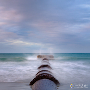 Dreamy abstract of an outfall pipe at Vazon Bay, Guernsey, with a square crop.