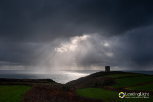 Rays of sunshine pierce through heavy showers at Prevote observation tower.