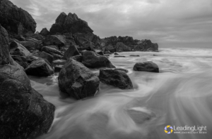 Black & white image of a receding tide at Le Jaonnet Bay, Guernsey.