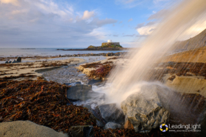 Excess groundwater pours onto Rocquaine Bay from an outfall in the sea wall after heavy rain.