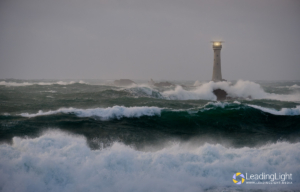 Rough seas crash around Le Hanois lighthouse during a winter storm.