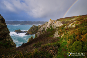 A rainbow forms over the cliffs, viewed from the Peastacks.