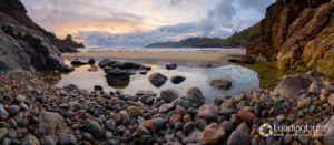 A storm had carved a large pool in the sand at Petit Port, pictured here at low tide.