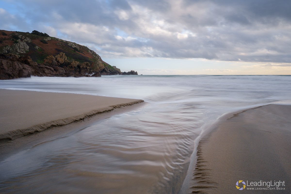 A freshwater rivulet empties into the sea at Le Jaonnet Bay, Guernsey