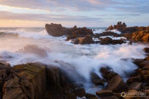 An uncharacteristic summer storm created huge waves at Grandes Rocques on Guernsey's west coast. Uniform grey cloud-cover broke just in time for sunset, which briefly bathed this dramatic scene in warm evening sunlight. Shortly after, and somewhat expectedly, a giant wave crashed over the rocks to my left, completely soaking both me and my camera, which needed a careful washdown after. I get wet so you don't have to!