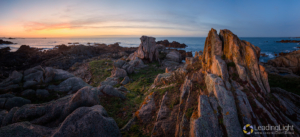Panoramic photo of rock towers on a small islet off Grandes Rocques on Guernsey's west coast.