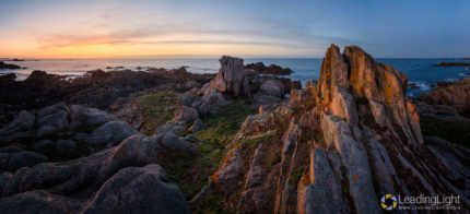 Panoramic photo of rock towers on a small islet off Grandes Rocques on Guernsey's west coast.